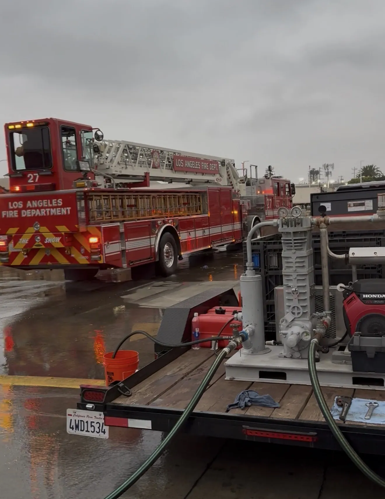 Ammonia transfer compressor and hoses on a REST LLC trailer with LAFD ladder truck 27 in the background