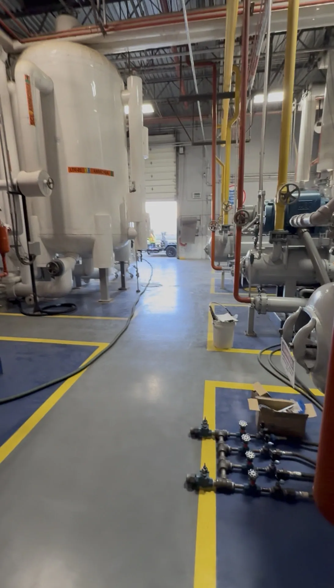 Ammonia machine room with low-temperature recirculator vessels and screw compressors