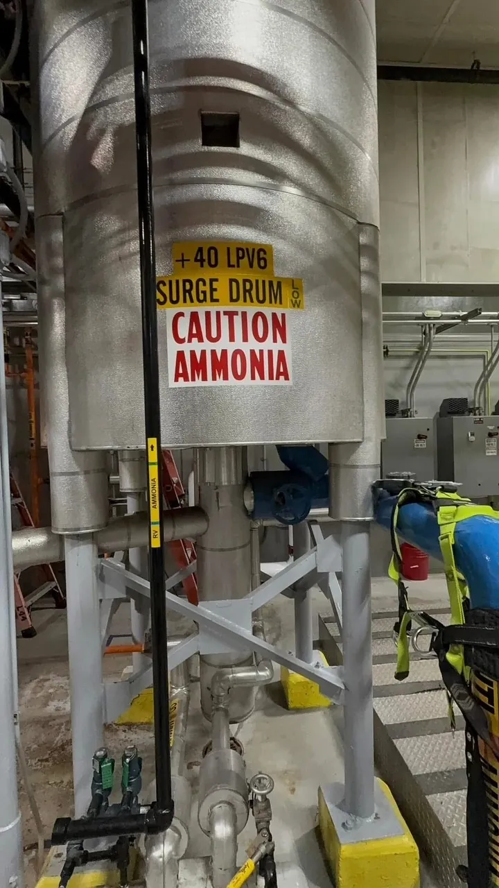Insulated ammonia surge drum with a caution ammonia label