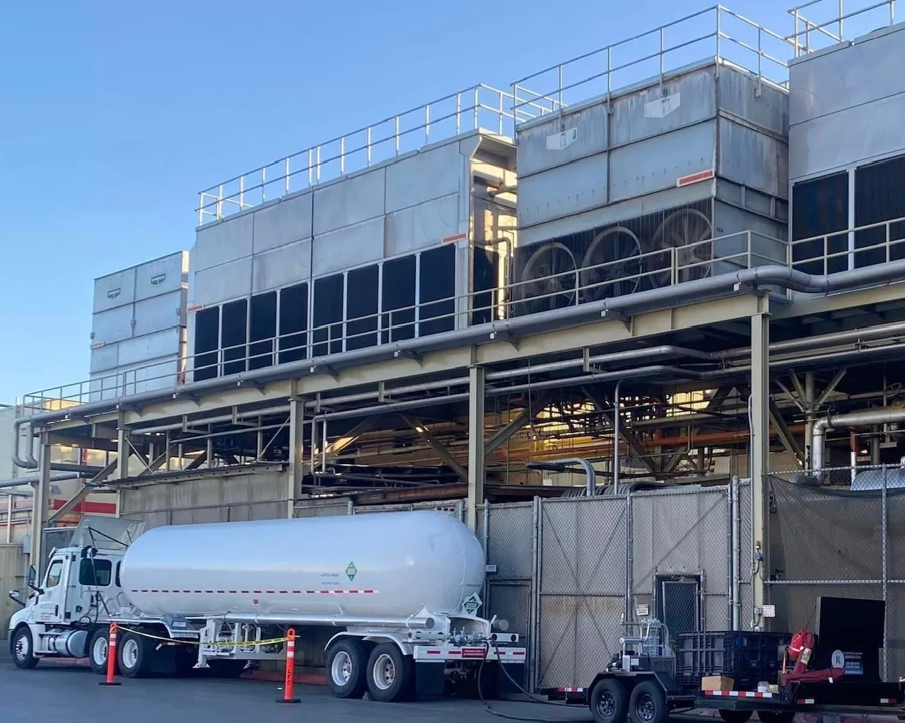 REST LLC tanker staged beneath evaporative condensers at a cold storage facility